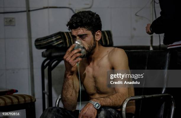 An affected man receives treatment after an alleged gas attack on Sakba and Hammuriye areas, in Eastern Ghouta, Syria on March 7, 2018. According to...