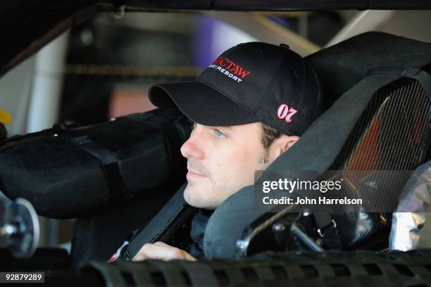 Casey Mears, driver of the Choctaw Casino Chevrolet, sits in his car during practice for the NASCAR Sprint Cup Series Dickies 500 at Texas Motor...