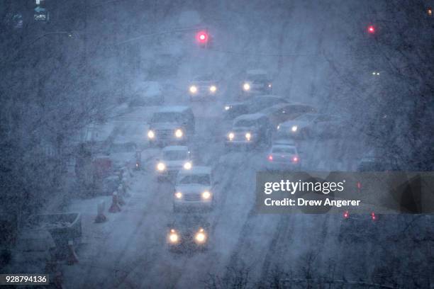 Vehicles navigate the road conditions on Atlantic Avenue in Brooklyn during a snowstorm, March 7, 2018 in New York City. Large portions of the East...