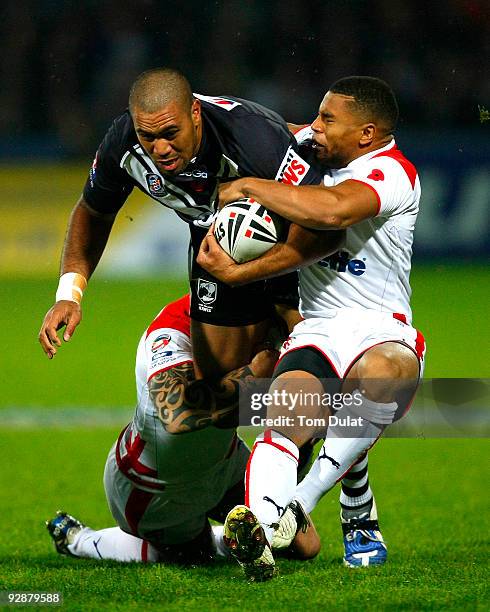 Frank Pritchard of New Zeland is challenged by Chris Bridge and Kyle Eastmond of England during the Gillette Four Nations match between England and...