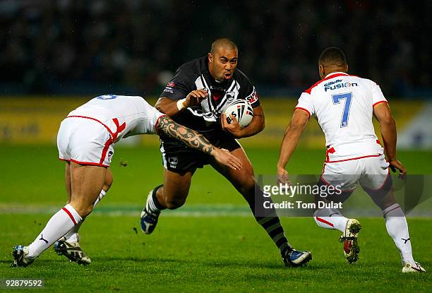 Frank Pritchard of New Zeland is challenged by Chris Bridge and Kyle Eastmond of England during the Gillette Four Nations match between England and...