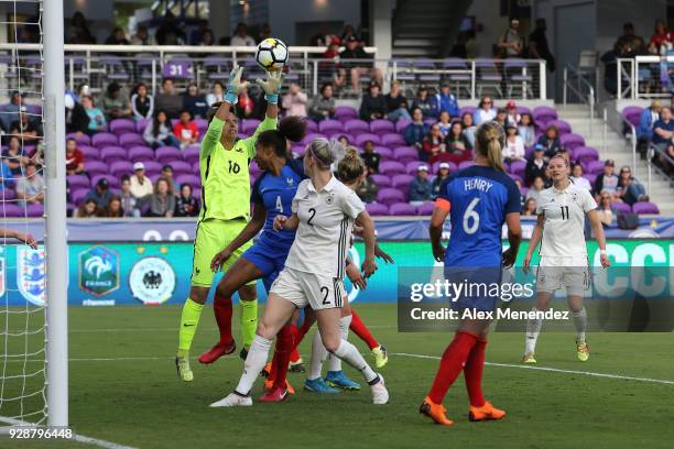 Sarah Bouhaddi of France makes a save in front of Laura Georges of France and Johanna Elsig of Germany during the SheBelieves Cup soccer match at...