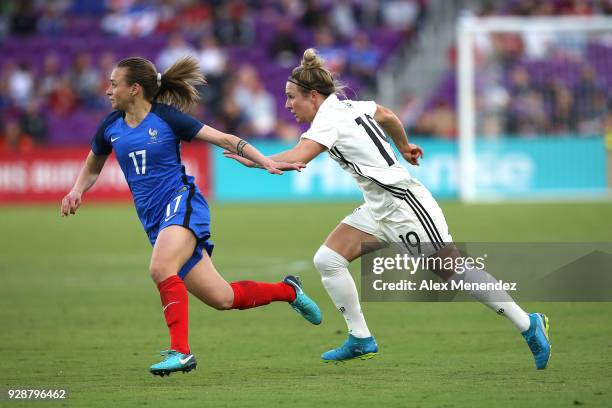 Marion Torrent of France and Svenja Huth of Germany chase the play during the SheBelieves Cup soccer match at Orlando City Stadium on March 7, 2018...