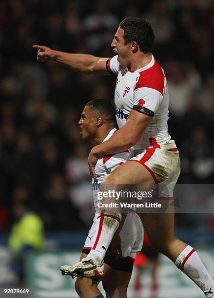 Kyle Eastmond of England is congratulated by team mate Sam Burgess after scoring a try during the Gillette Four Nations match between England and New...