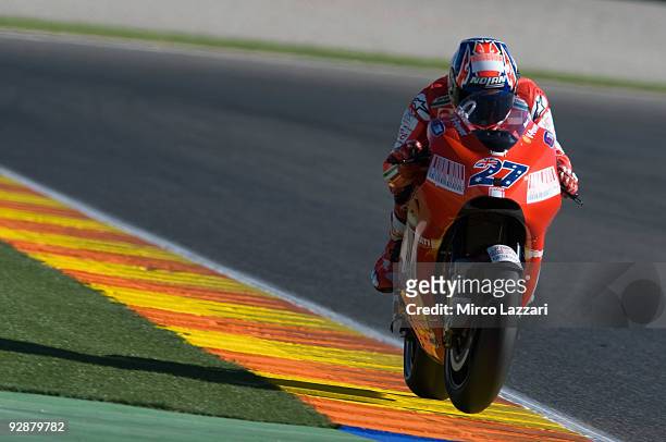 Casey Stoner of Australia and Ducati Marlboro lifts his front wheel during the qualifying practice session ahead of the MotoGP Of Valencia at the...
