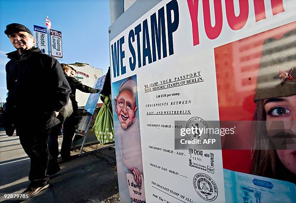 Tourists are offered "Berlin Wall" stamps in their passports at a souvenir shop on the section of the Berlin Wall known as the "East Side Gallery" in...