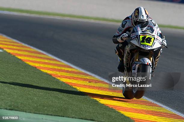 Randy De Puniet of France and LCR Honda MotoGP lifts his front wheel during the qualifying practice session ahead of the MotoGP Of Valencia at the...