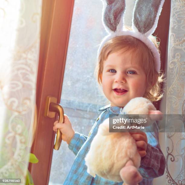 baby with rabbit ears in easter - baby bunny stock pictures, royalty-free photos & images