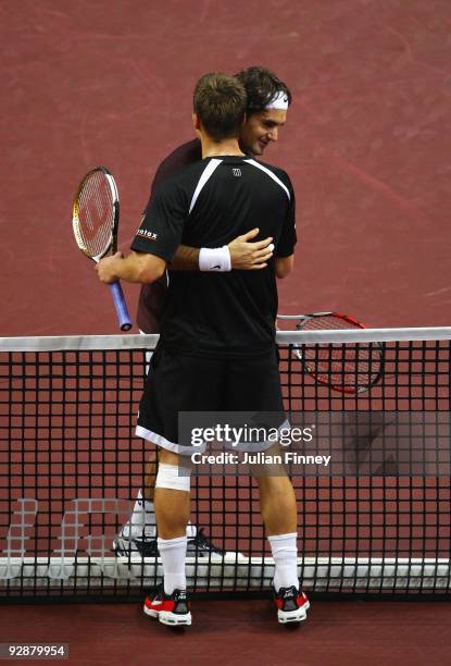 Roger Federer of Switzerland is congratulated by fellow countryman Marco Chiudinelli of Switzerland during Day Six of the Davidoff Swiss Indoors...