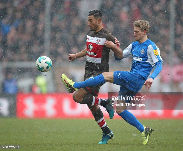 Aziz Bouhaddouz of St. Pauli and Johannes van den Bergh of Holstein Kiel battle for the ball during the Second Bundesliga match between FC St. Pauli...