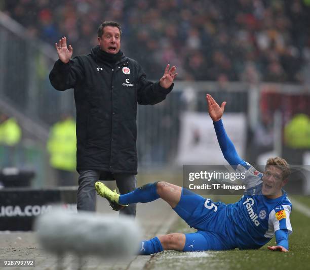 Head coach Markus Kauczinski of St. Pauli gestures and Johannes van den Bergh of Holstein Kiel on the ground during the Second Bundesliga match...