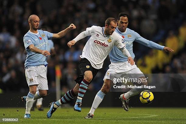 Steven Fletcher of Burnley is closed down by Stephen Ireland and Joleon Lescott of Manchester City during the Barclays Premier League match between...