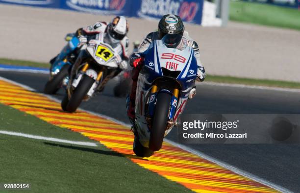 Jorge Lorenzo of Spain and Fiat Yamaha lifts the front wheel during qualifying ahead of the MotoGP of Valencia at the Valencia Circuit on November 6,...