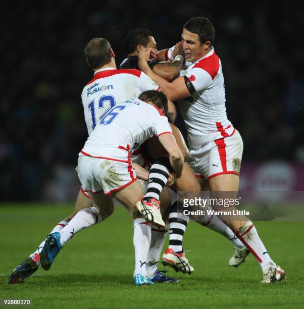 Junior Sau of New Zealand is mob tackled by the English defence during the Gillette Four Nations match between England and New Zealand at Galpharm...