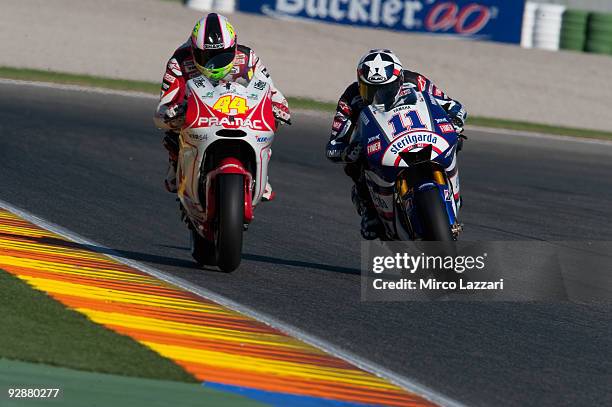 Aleix Espargaro of Spain and Pramac Racing and Ben Spies of USA and Yamaha Factory Racing head down a straight during qualifying ahead of the MotoGP...