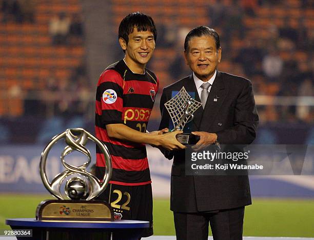 Byung jun No of Pohang Steelers receives the MVP award from Saburo Kawabuchi during the awards ceremony of 2009 AFC Champions League Final match...