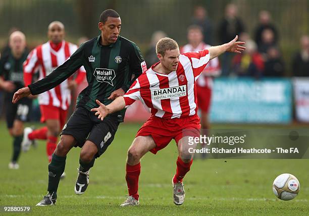 Sean Evans of Stourbridge battles for the ball with Dwayne Mattis of Walsall the FA Cup 1st Round Proper Match between Stourbridge and Walsall at The...