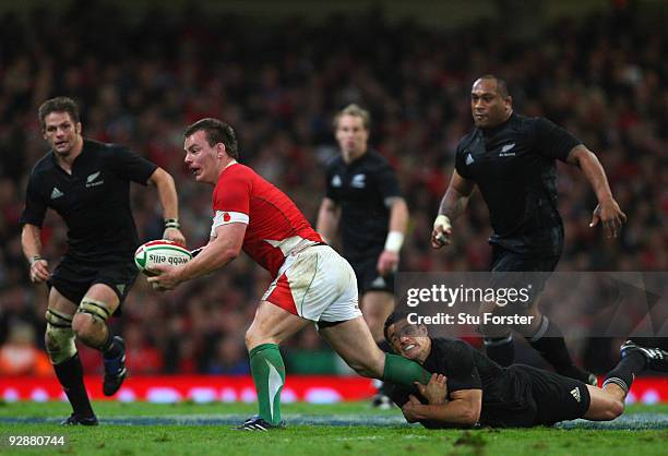 Wales forward Matthew Rees is tackled by all blacks fly half Dan Carter during the Invesco Perpetual series match between Wales and New Zealand at...