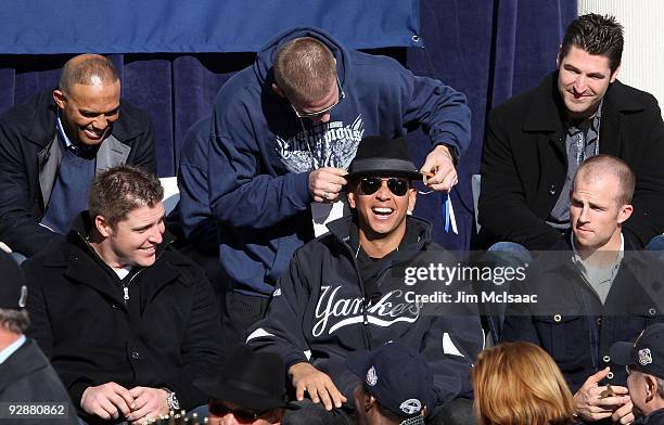 Alex Rodriguez of the New York Yankees has a laugh with teammate A.J. Burnett during the New York Yankees World Series Victory Celebration at City...