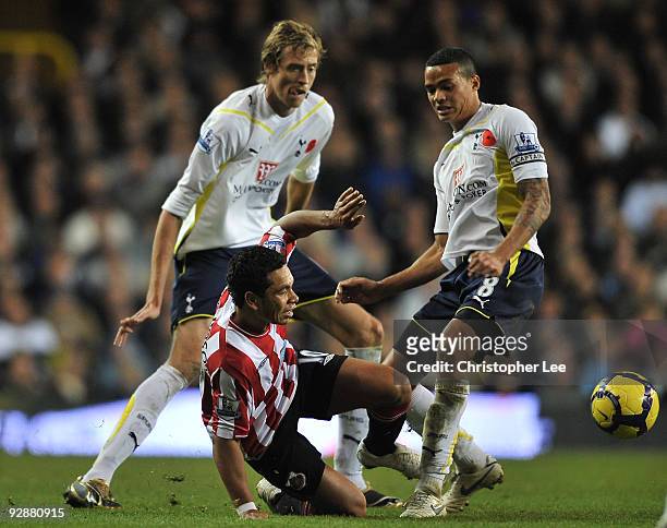 Kieran Richardson of Sunderland is tackled by Peter Crouch and Jermaine Jenas of Tottemham Hotspur during the Barclays Premier League match between...