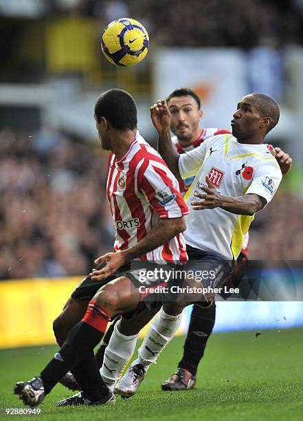 Jermain Defoe of Tottenham Hotspur flicks the ball over Steed Malbranque and Paulo Da Silva of Sunderland during the Barclays Premier League match...