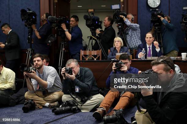 Sen. Ron Wyden and Sen. Patty Murray are surrounded by journalists during a meeting about gun violence in the visitors center at the U.S. Capitol...
