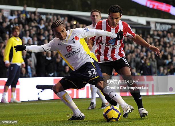 Benoit Assou-Ekotto of Tottenham Hotspur is closed down by Kieran Richardson of Sunderland during the Barclays Premier League match between Tottenham...