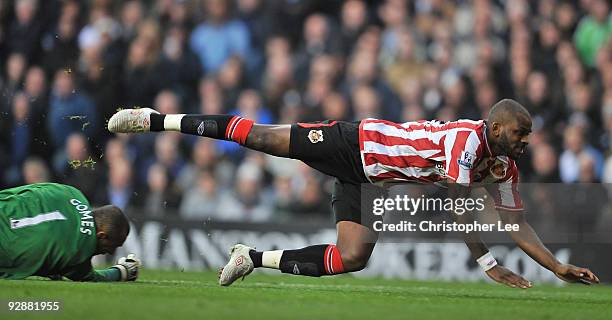 Darren Bent of Sunderland is tackled by Heurelho Gomes of Tottenham Hotspur during the Barclays Premier League match between Tottenham Hotspur and...