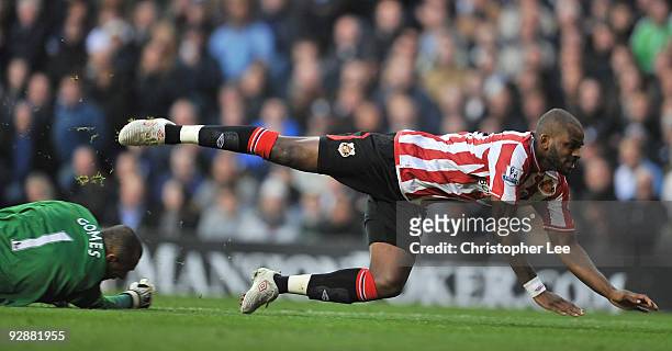 Darren Bent of Sunderland is tackled by Heurelho Gomes of Tottenham Hotspur during the Barclays Premier League match between Tottenham Hotspur and...