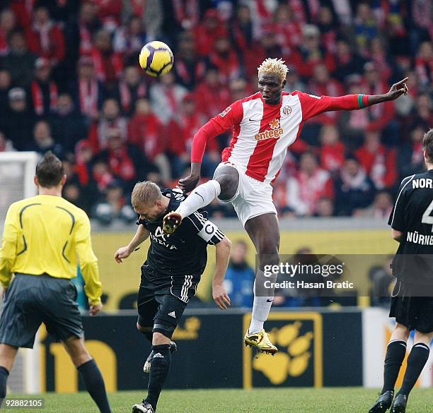 Aristide Bance of Mainz battles for the ball with Andreas Wolf of Nuernberg during the Bundesliga match between FSV Mainz 05 and 1. FC Nuernberg at...