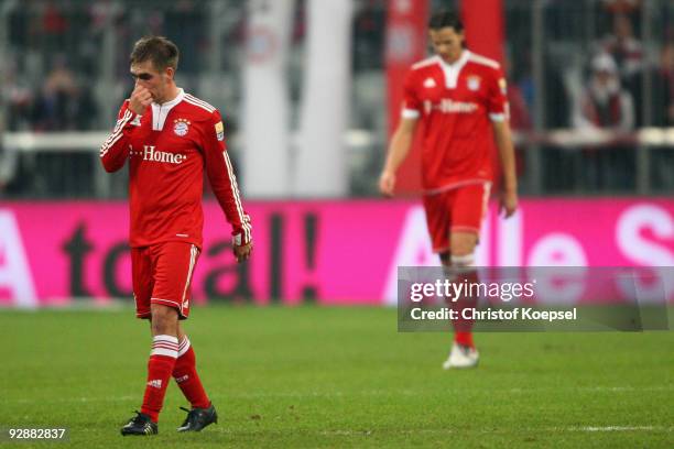 Philipp Lahm of Bayern and Daniel van Buyten of Bayern look dejected after the 1-1 draw in the Bundesliga match between Bayern Muenchen and FC...