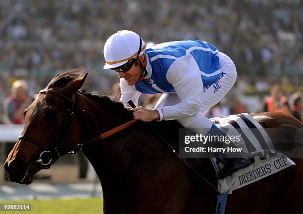 Jockey Olivier Peslier celebrates as he crosses the finish line to win the TVG Breeders' Cup Mile race with Goldikova during the Breeders' Cup World...