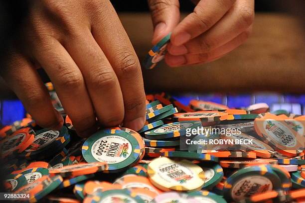 Player sorts his chips at the final table at the World Series of Poker , at the Penn & Teller Theater at the Rio Hotel in Las Vegas, Nevada on...