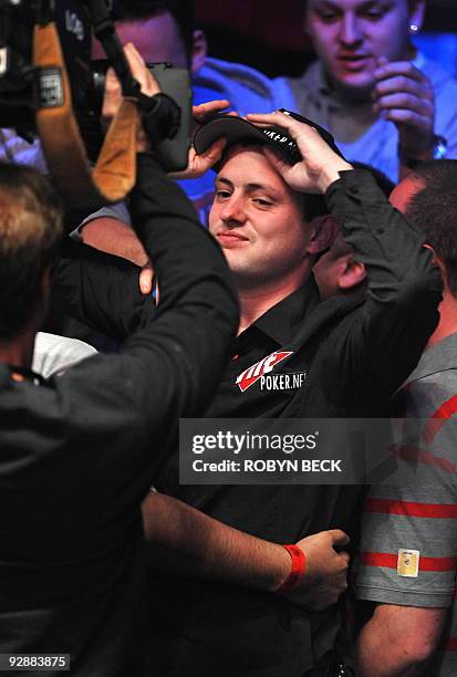 James Akenhead of England is hugged by supporters as he wins his all-in hand at the final table at the World Series of Poker , at the Penn & Teller...