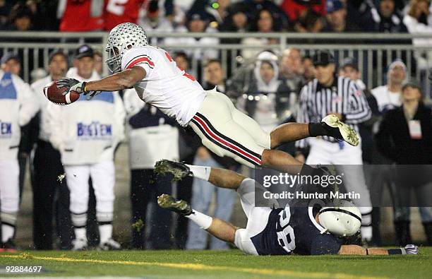 Running back Brandon Saine of the Ohio State Buckeyes dives for the end zone and scores a 6 yard touchdown during a game against the Penn State...