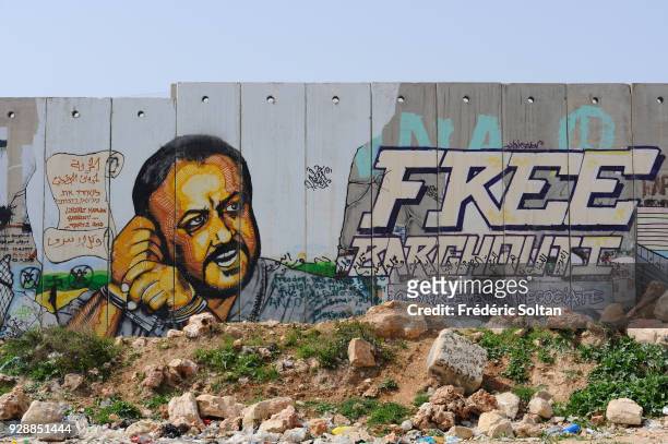 Mural on wall at Qalandia Checkpoint. Political and social mural painting and graffitis illustrating Palestinian politician Marwan Barghouti on the...