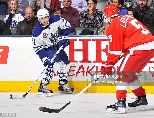 Phil Kessel of the Toronto Maple Leafs looks to pass the puck as Nicklas Lidstrom of the Detroit Red Wings defends during game action November 7,...