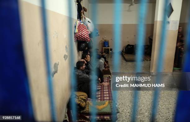 Palestinians who are unable to pay off their debts, sit in a cell in a Hamas jail in Gaza City on February 20, 2018. Over 40,000 Gazans were charged...