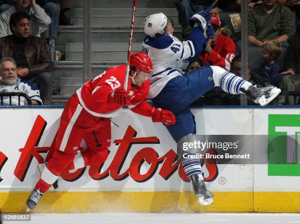 Nikolai Kulemin of the Toronto Maple Leafs is hit by Brad Stuart of the Detroit Red Wings at the Air Canada Centre on November 7, 2009 in Toronto,...