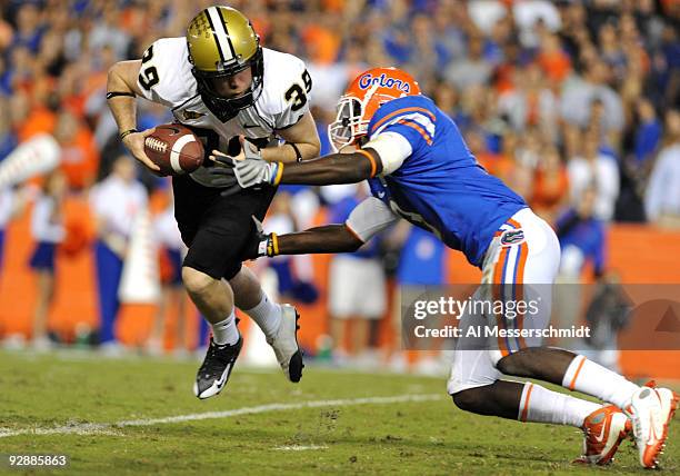 Punter Brett Upson of the Vanderbilt Commodores dodges a tackle after a bad snap against the Florida Gators November 7, 2009 at Ben Hill Griffin...