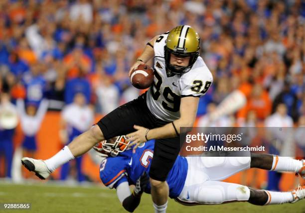 Punter Brett Upson of the Vanderbilt Commodores dodges a tackle after a bad snap against the Florida Gators November 7, 2009 at Ben Hill Griffin...