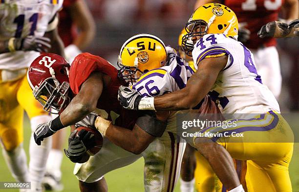 Mark Ingram of the Alabama Crimson Tide is tackled by Perry Riley and Danny McCray of the Louisiana State University Tigers at Bryant-Denny Stadium...