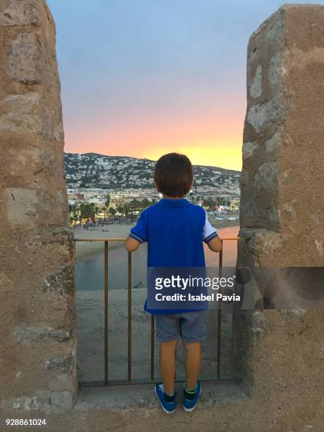 child by balcony looking at sunset - costa_del_azahar stock pictures, royalty-free photos & images