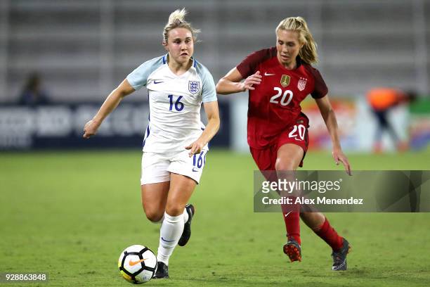 Izzy Christiansen of England dribbles past Allie Long of United States during the SheBelieves Cup soccer match at Orlando City Stadium on March 7,...
