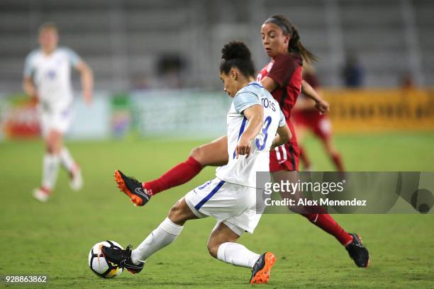 Demi Stokes of England kicks the ball past Mallory Pugh of United States during the SheBelieves Cup soccer match at Orlando City Stadium on March 7,...