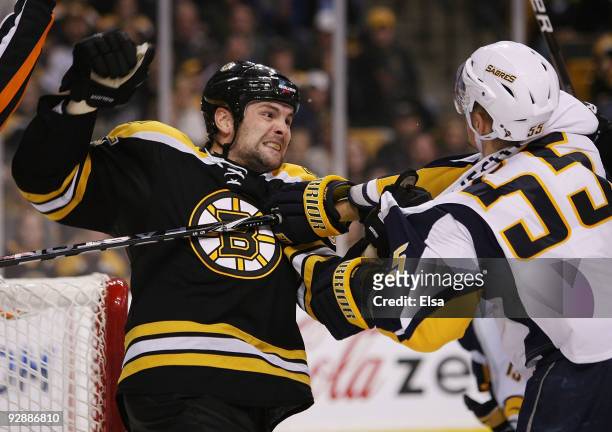 Mark Stuart of the Boston Bruins and Jochen Hecht of the Buffalo Sabres exchange punches in the third period on November 7, 2009 at the TD Garden in...