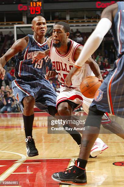 John Salmons of the Chicago Bulls drives past Raja Bell and Gerald Wallace of the Charlotte Bobcats during the NBA game on November 7, 2009 at the...