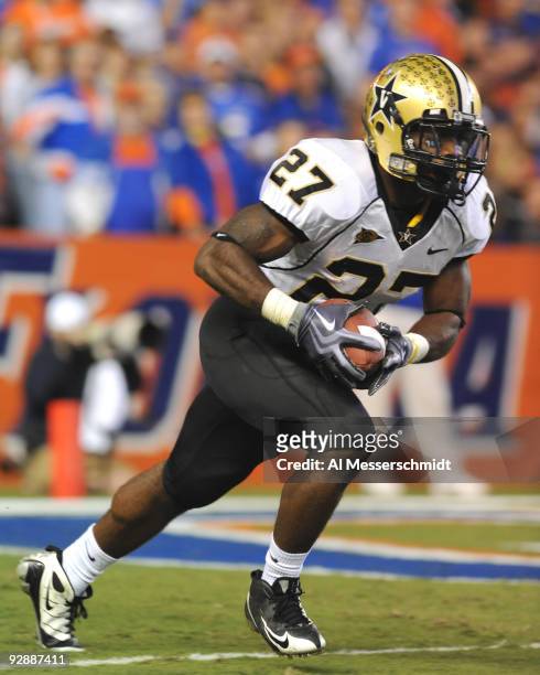Running back Warren Norman of the Vanderbilt Commodores rushes upfield with a kick against the Florida Gators November 7, 2009 at Ben Hill Griffin...