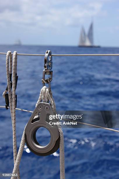 sailboat equipment with yacht on the background - pully stock pictures, royalty-free photos & images