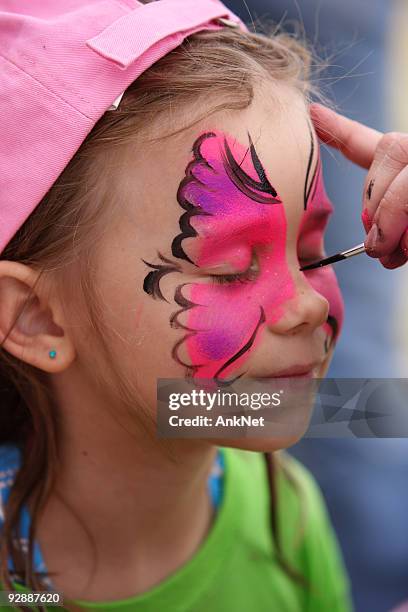 face painting at the party. - draw a butterfly stock pictures, royalty-free photos & images